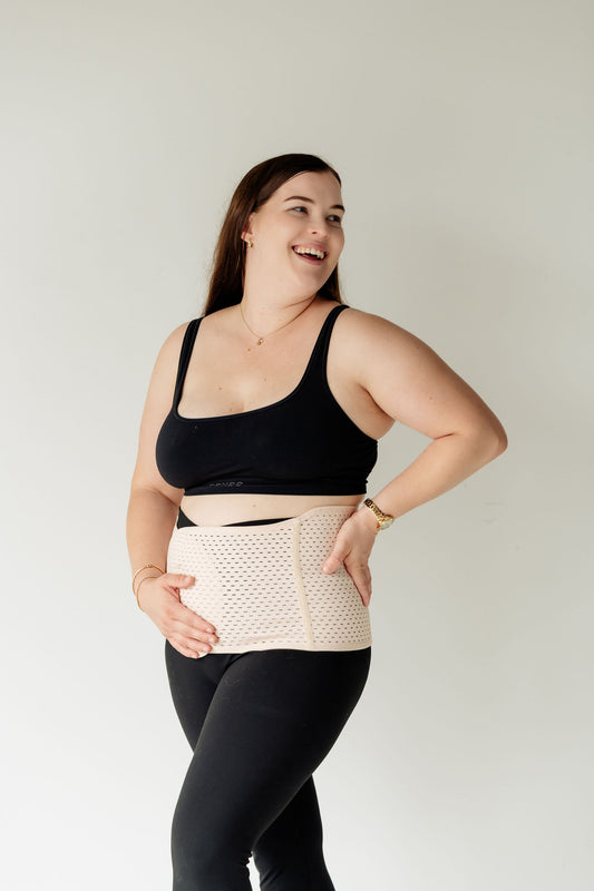 Postpartum woman wearing Partum Panties postpartum support band for bump and back support